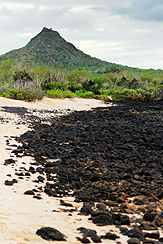 lava covered beach with a volcano in the background